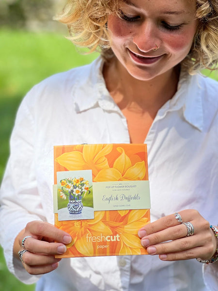 Model holds envelope containing greeting card