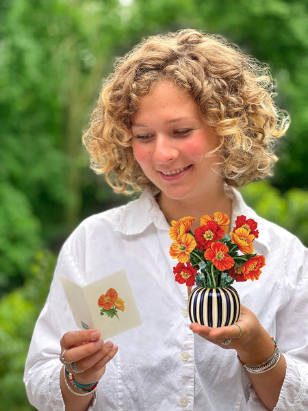 Model holds Mini French Poppies greeting card and reads personal notecard