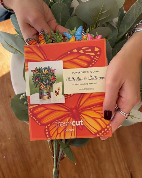 model pulls greeting card from envelope