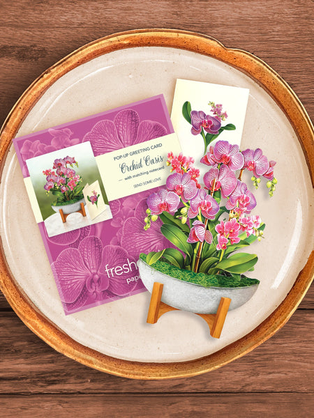 greeting card, envelope and notecard together on a plate.
