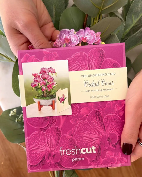 Model pulls greeting card from Orchid Oasis envelope