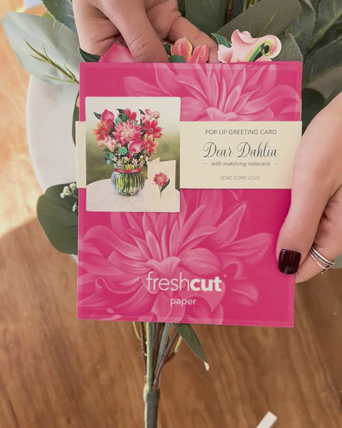 woman pulls Dahlia greeting card from envelope
