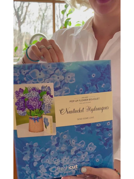 Woman takes greeting card out of envelope