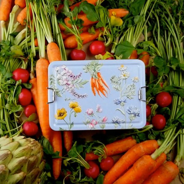 Handcare and Essentials Tin surrounded by carrots, tomatoes and artichokes