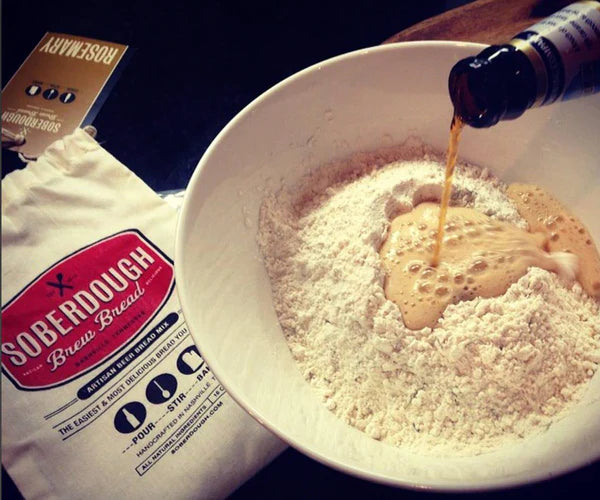 Pouring a bottle of beer into a bowl of soberdough Brew Bread Mix