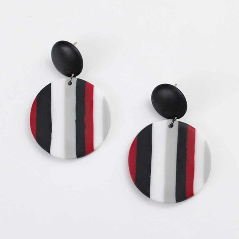 Close up view of Red, black and white striped Finley disk earrings