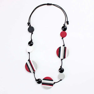 Close up view of red, black and white Finley necklace