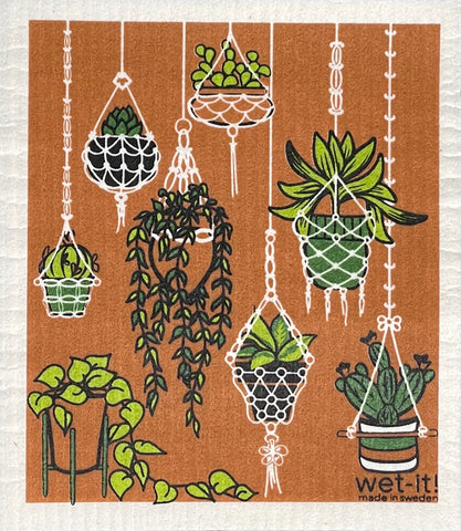 Dishcloth with print of macrame plant hangers holding an assortment of houseplants