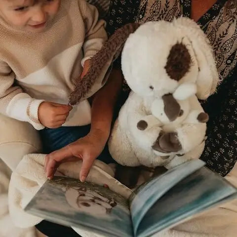 Mother and child reading What Will My Grandchild Call Me story book