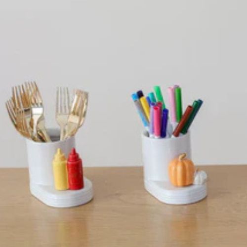 Cutie containers filled with colored pens and silverware