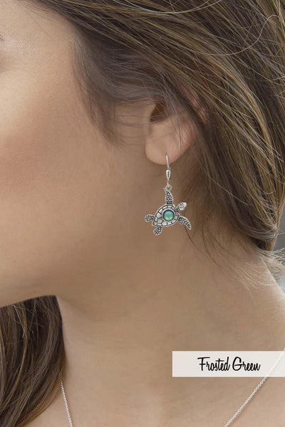 model wearing sea turtle earrings