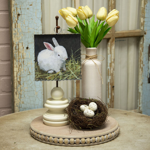 Baby Bunny print in tabletop display with a vase of tulips and next with eggs