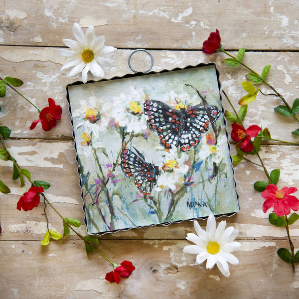 Checkered Butterflies print on wood background surrounded by flowers