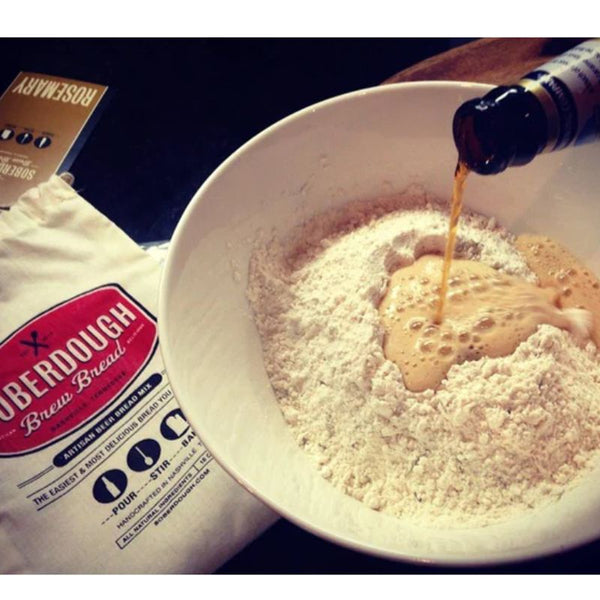 Pouring beer into bowl of Soberdough Rosemary  Brew Bread Mix